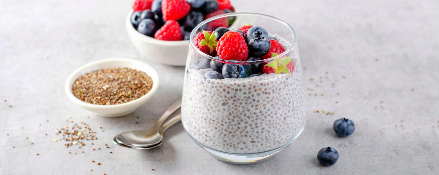 A Chia Pudding Topped With Fruit Next To a Bowl of Chia Seeds