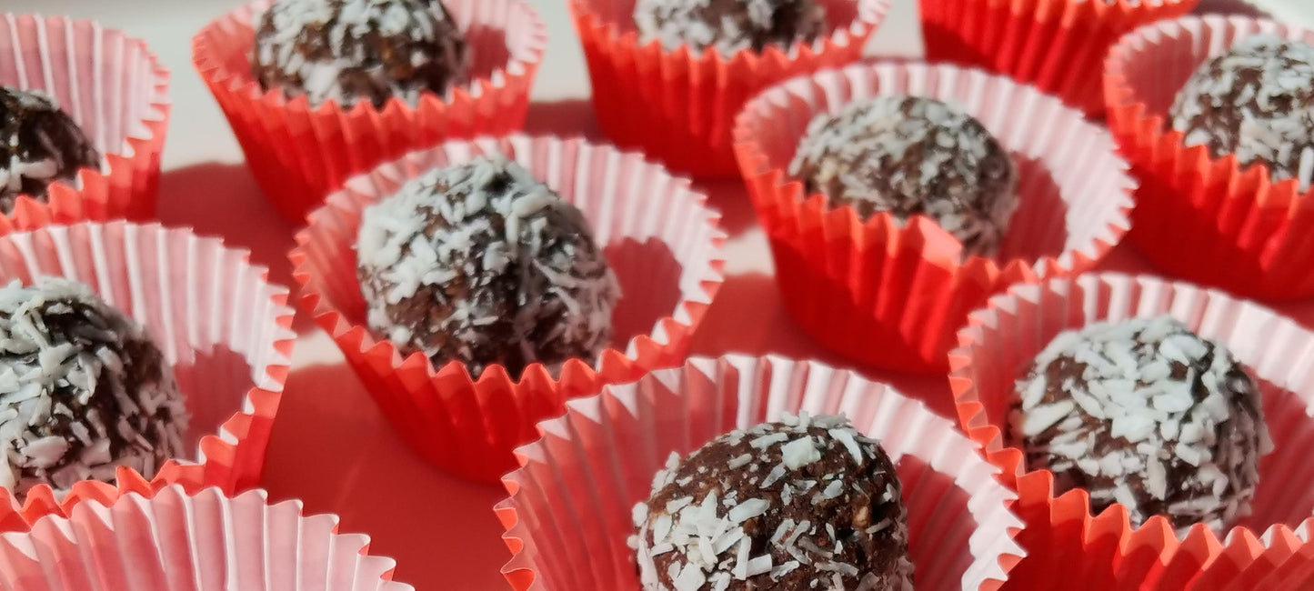 Maca Bliss Bites rolled in shredded coconut, packed with nutrient-dense Struesli granola.