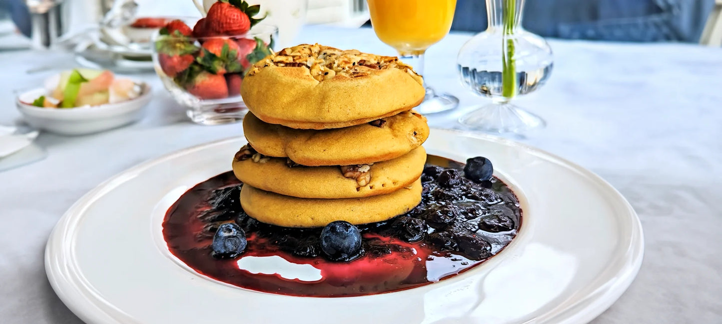 A delicious stack of gluten-free superfood pancakes on top of blueberry compote.