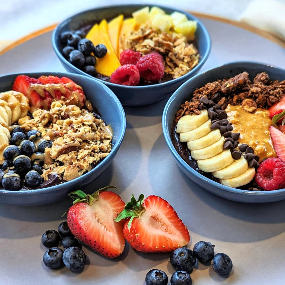 Three fruity variations of acai bowls topped with Struesli's organic granola.
