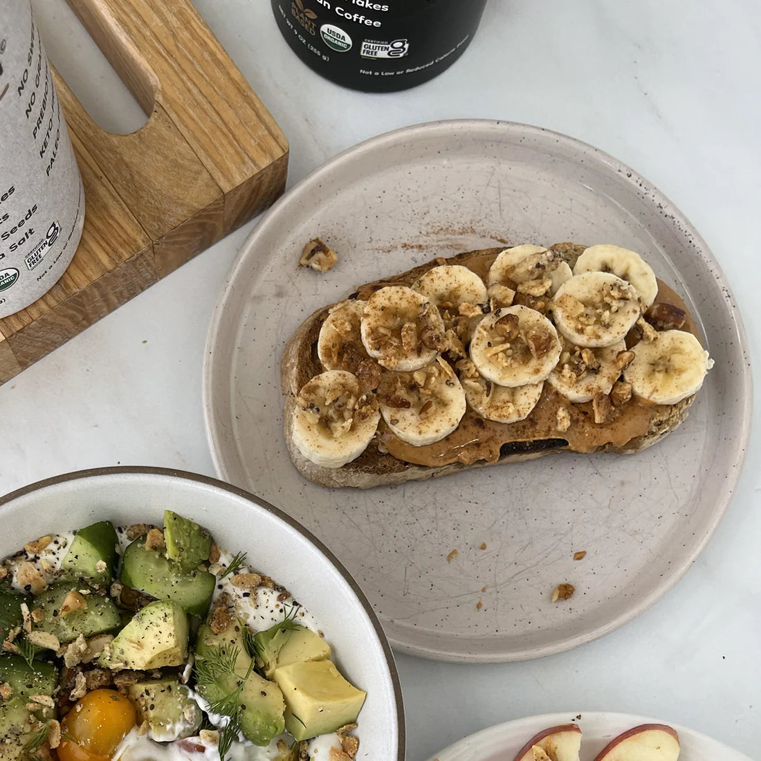 Peanut butter toast topped with banana and crunchy Struesli granola.
