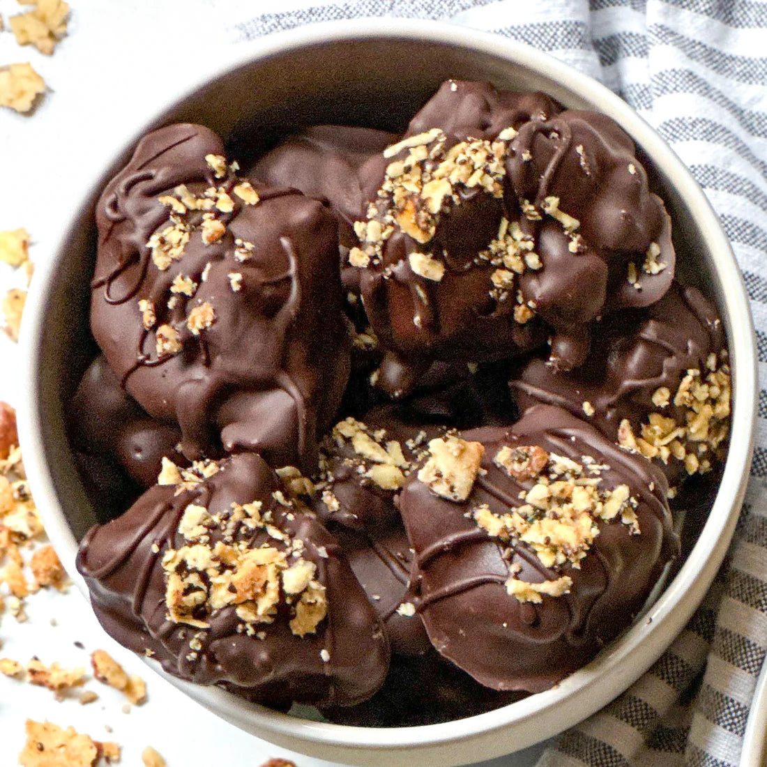 A bowl of snack-sized chocolate covered peanut butter banana bites made with Struesli's original granola.