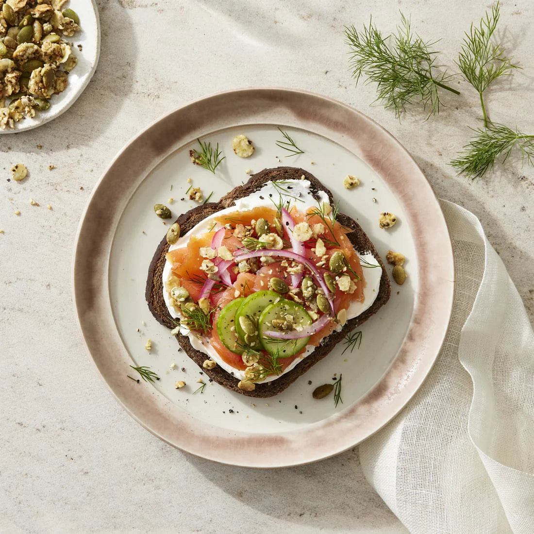 Smoked salmon on rye with savory granola crunch.