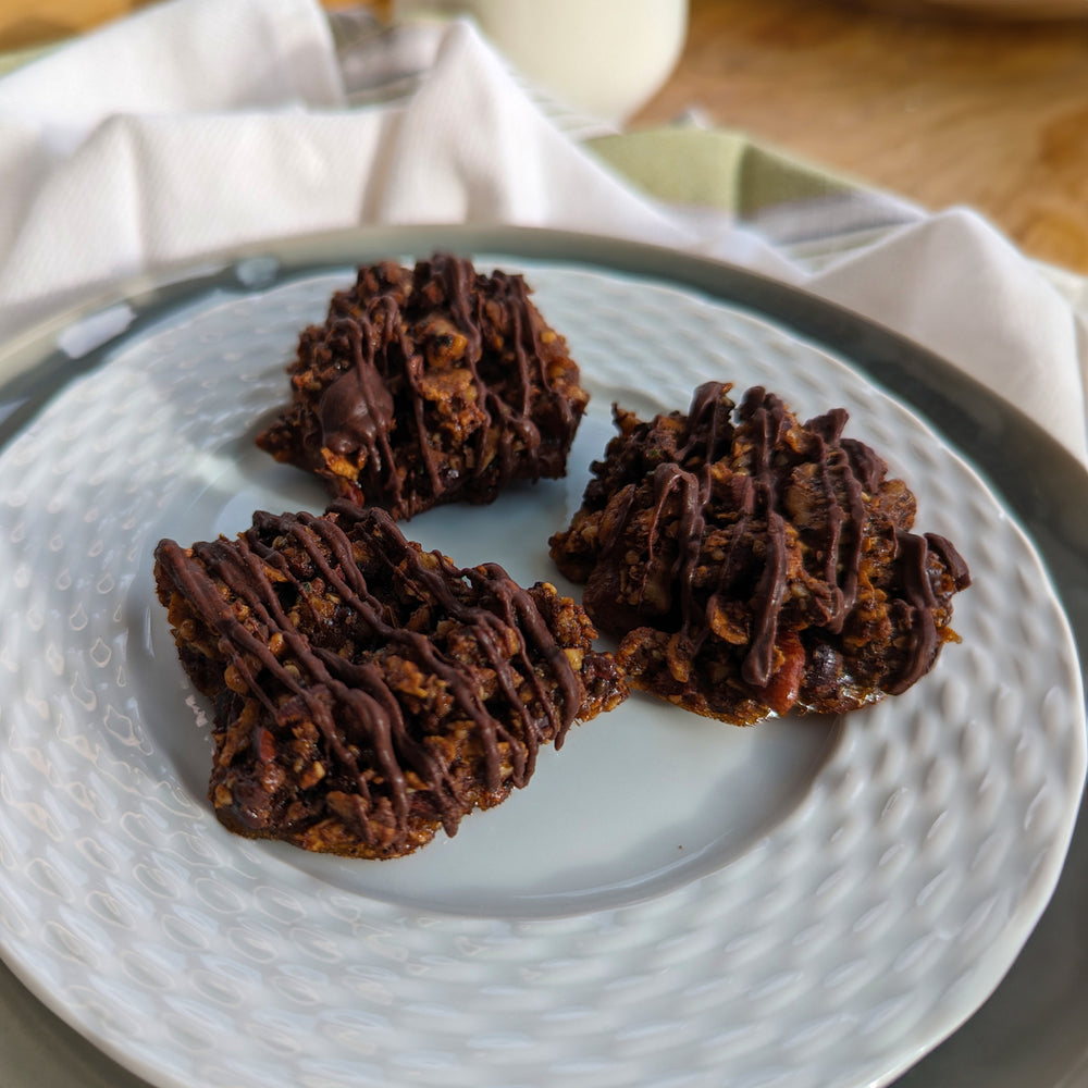 A few three-ingredient cookies made with Struesli Cacao + Coffee granola on a plate