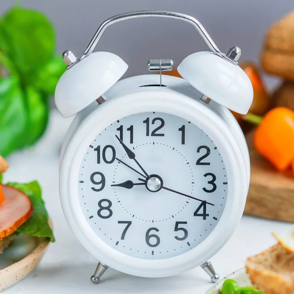 A clock on a breakfast table