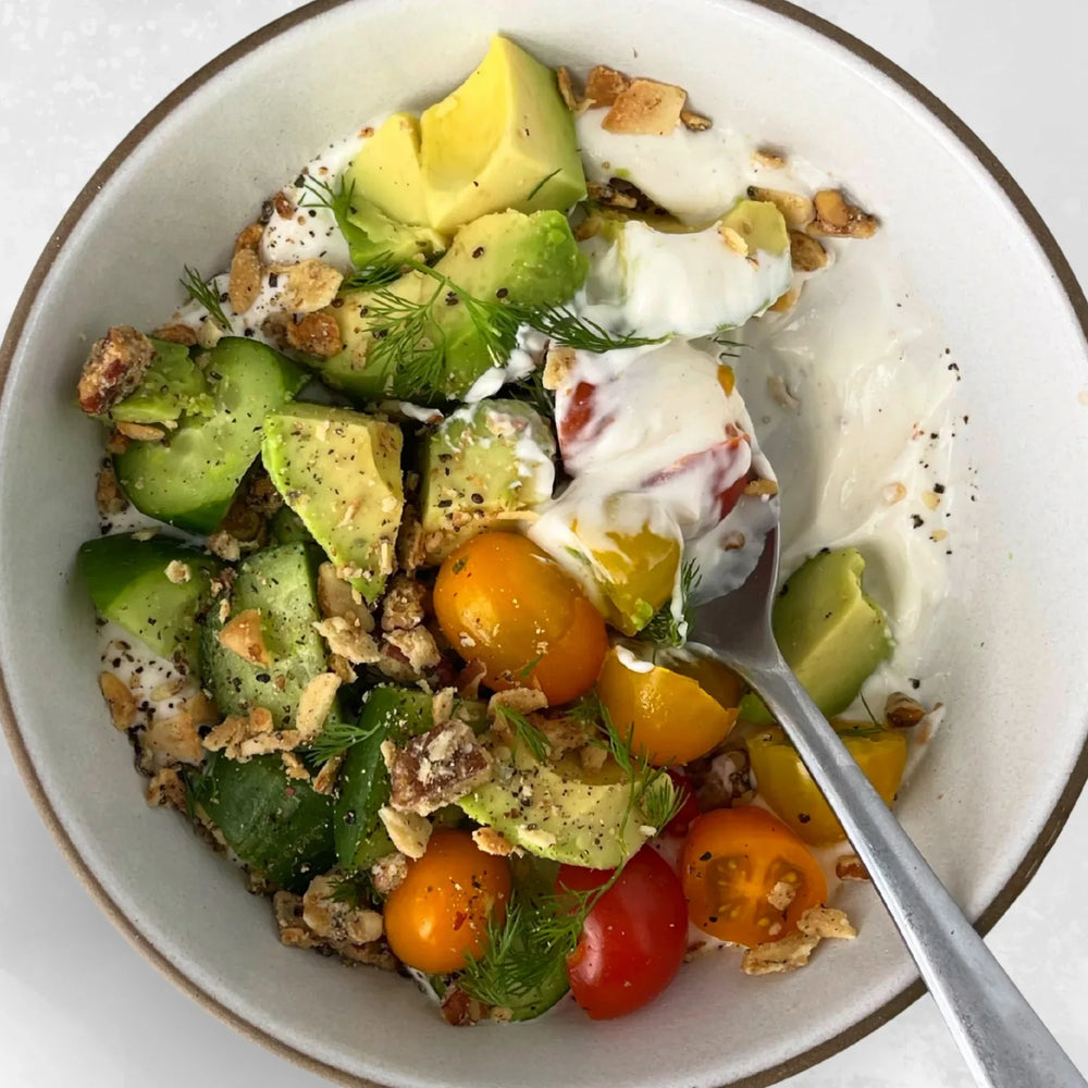 A savory yogurt bowl topped with Struesli's grain-free granola and veggies