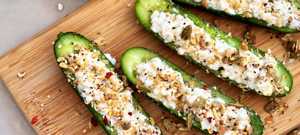 Sliced cucumbers topped with cottage cheese and Struesli's savory + seed granola for a satisfying snack.