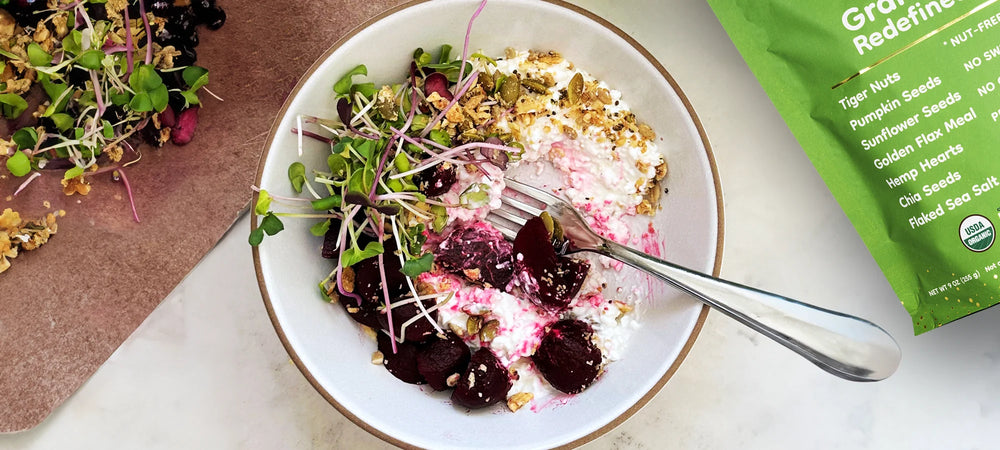 A nut-free cottage cheese bowl topped with greens, beets and nutrient-rich Struesli granola.