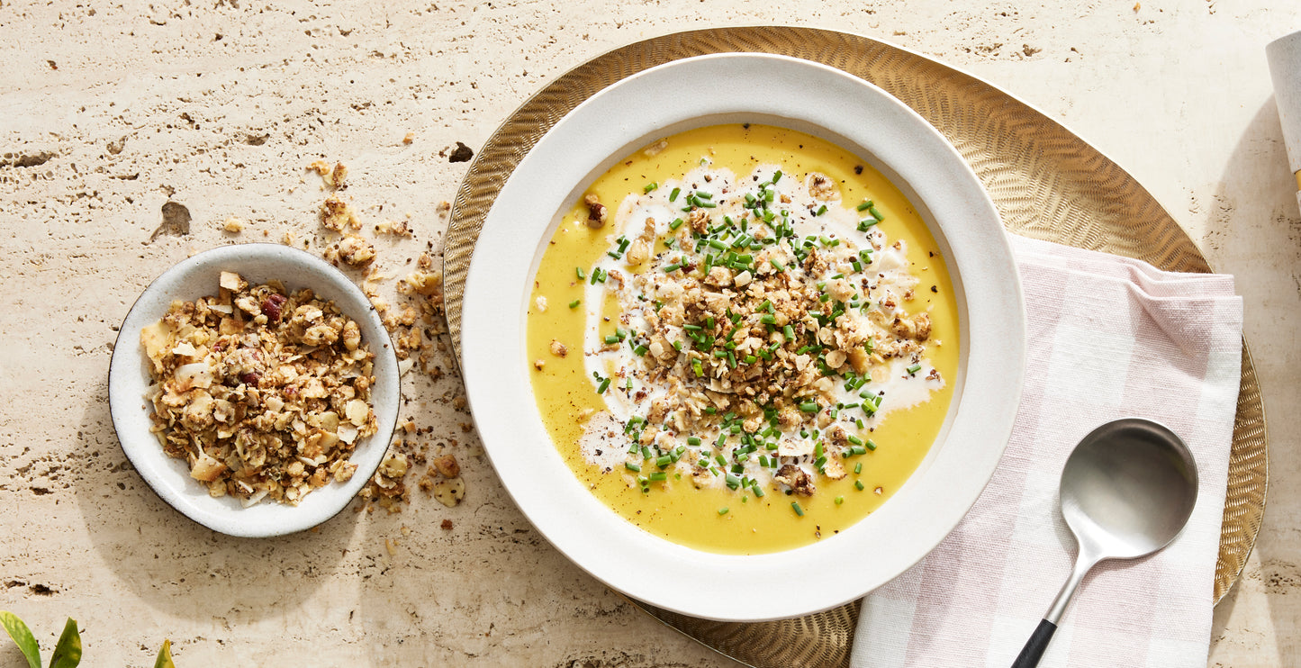 A comforting bowl of curried butternut squash bisque topped with Struesli granola for satisfying crunch.