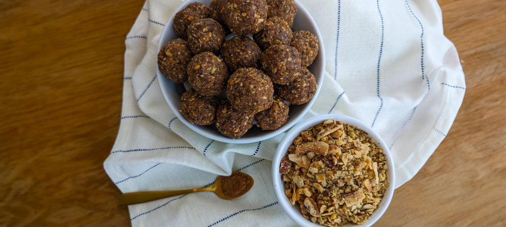 A bowl of stacked struesli bliss bites using the rich flavor of cinnamon and walnuts.