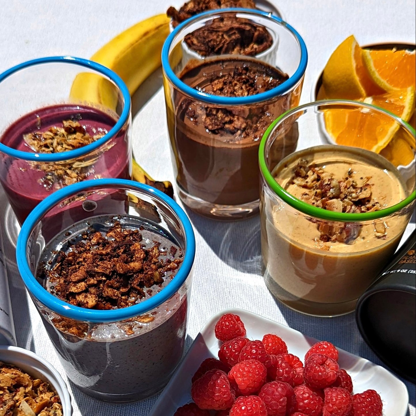 Glasses with various types of smoothies topped with Struesli granola 