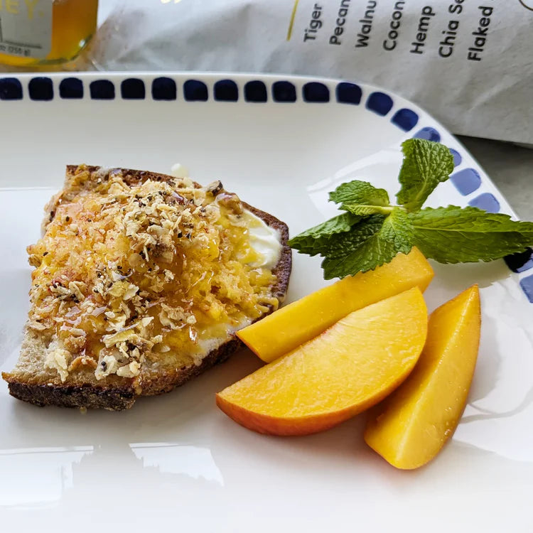 Mascarpone toast with shaved frozen peach, honey and granola.