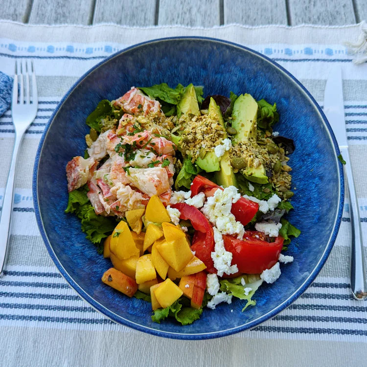 Summer salad with lobster, peach and savory granola.