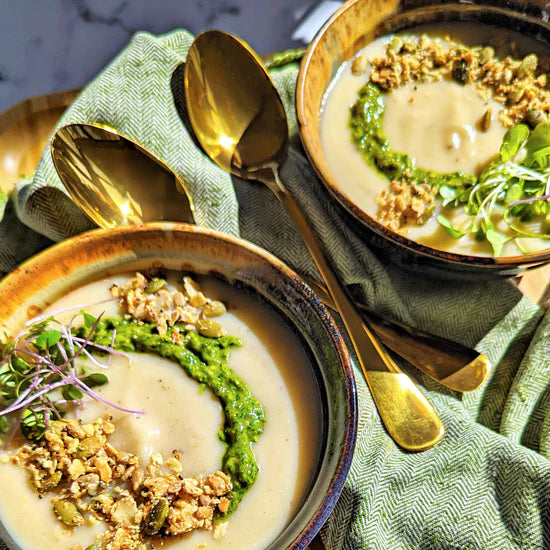 Creamy cauliflower soup with granola and basil pesto.