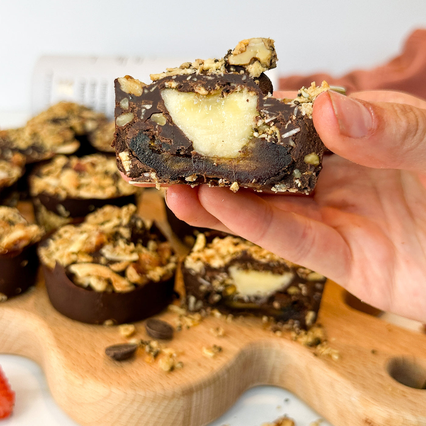 A cross section of a chocolate date bite with banana in the center and made with Struesli Original