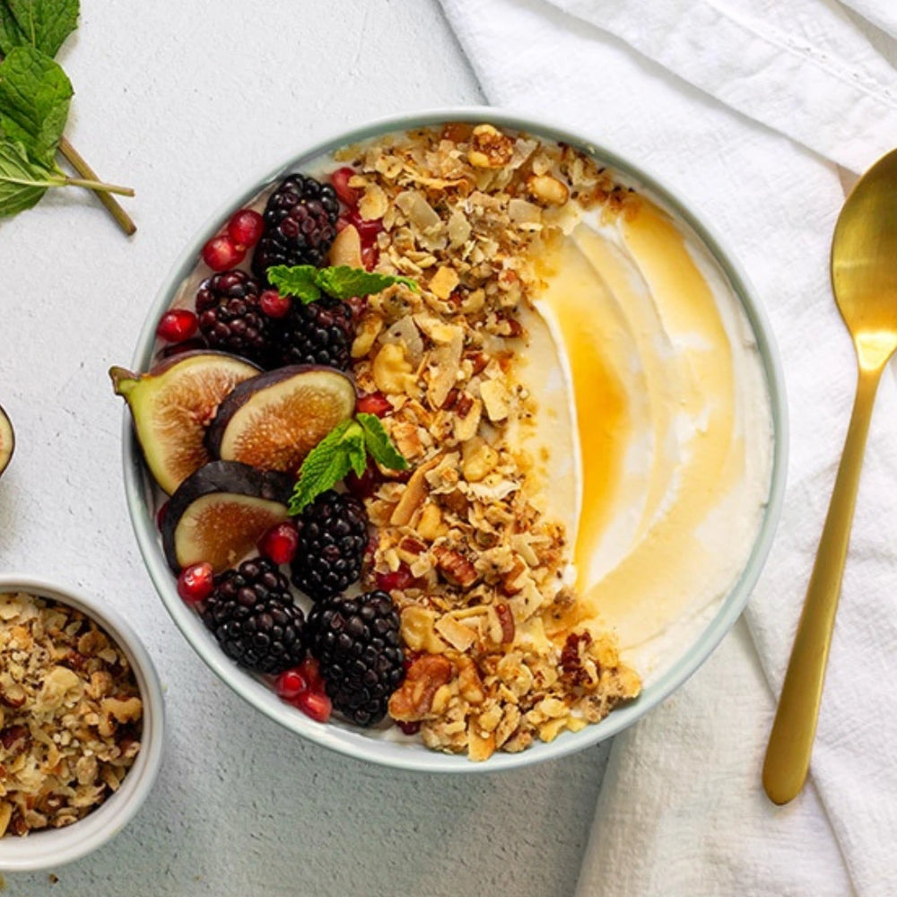 A yogurt bowl topped with Struesli Original granola and figs