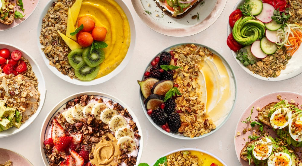 A variety of yogurt bowls and dishes topped with Struesli Granola Redefined