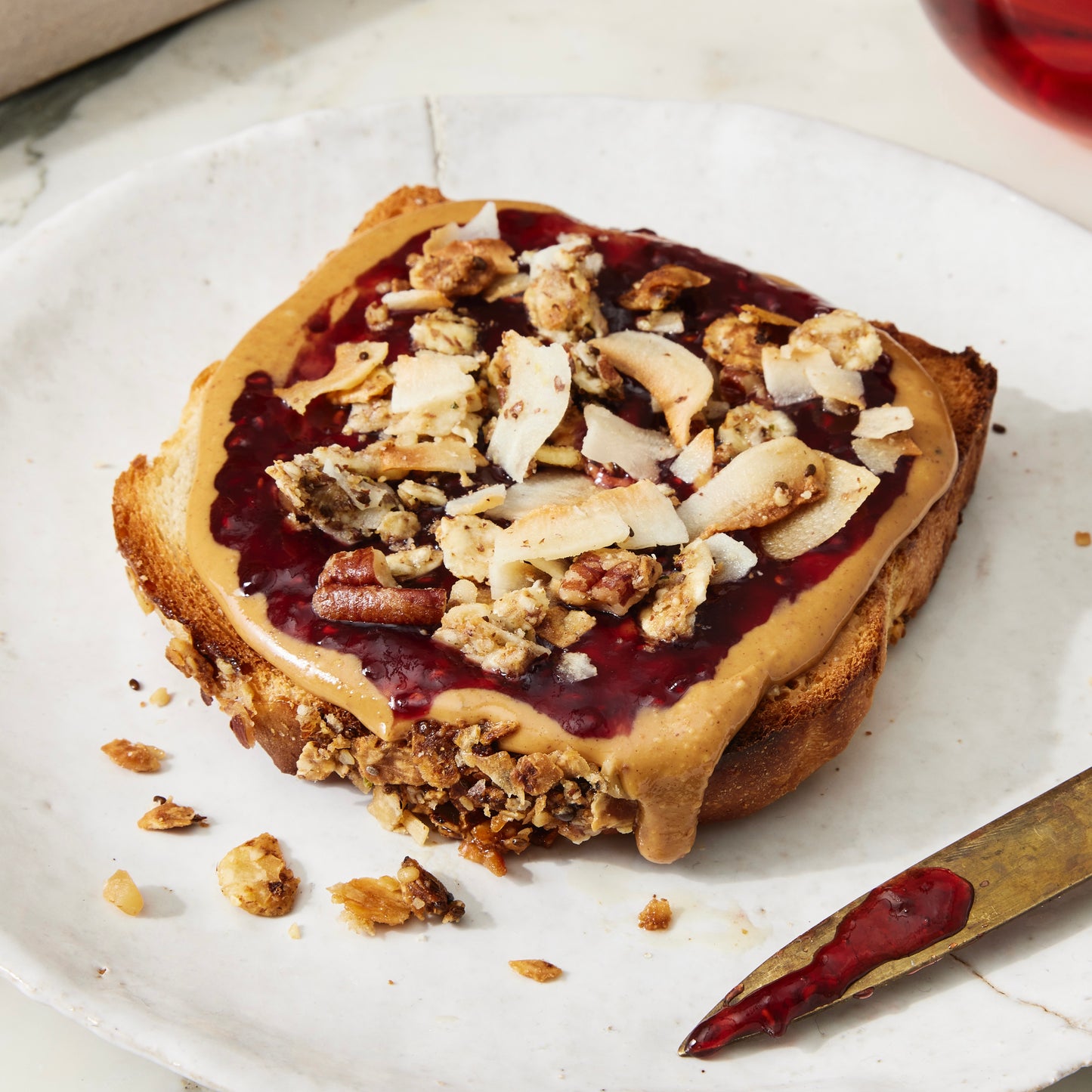 Toast topped with nut butter, jam and Struesli Cacao + Coffee