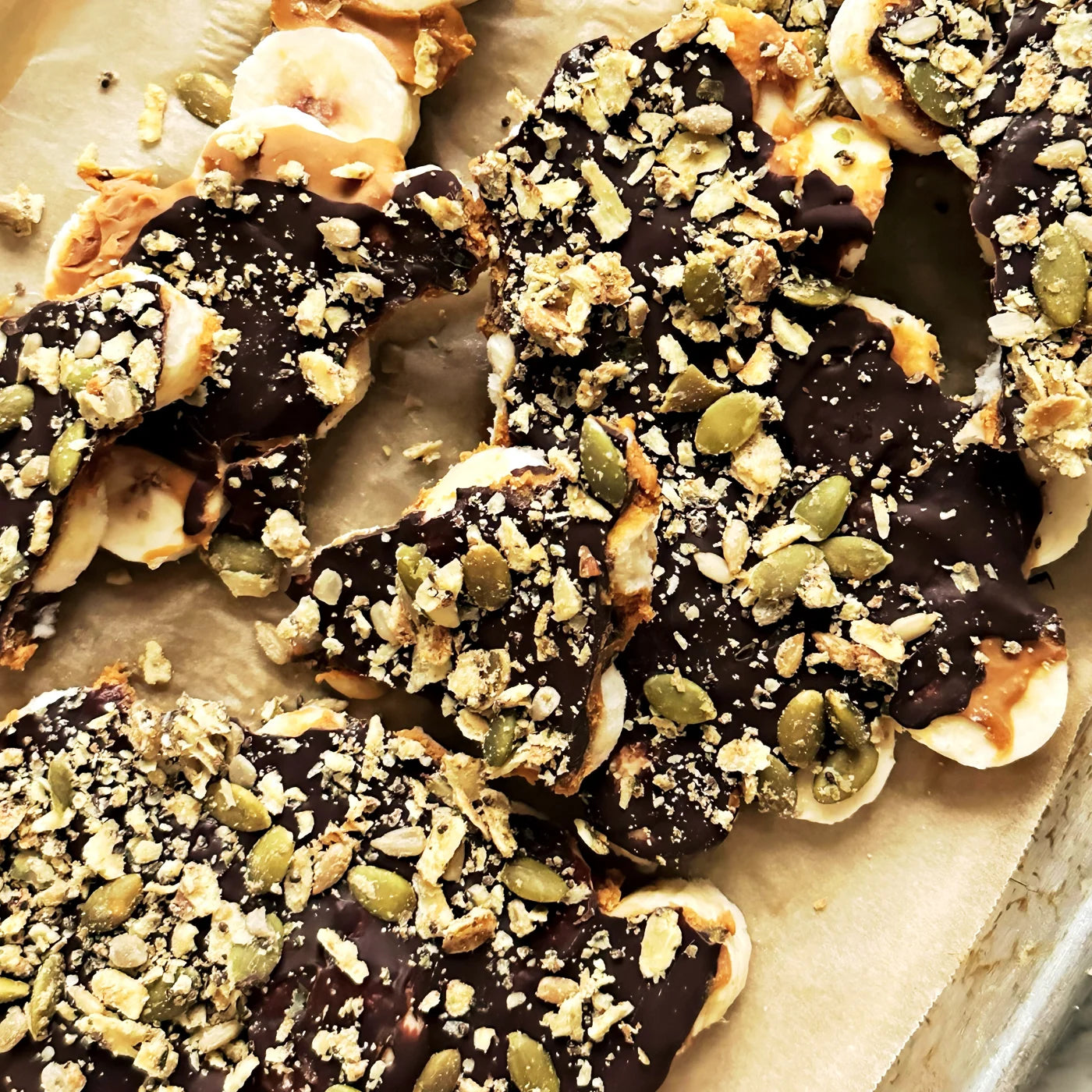 Frozen banana bark with chocolate, peanut butter and Struesli Savory + Seed sprinkled atop
