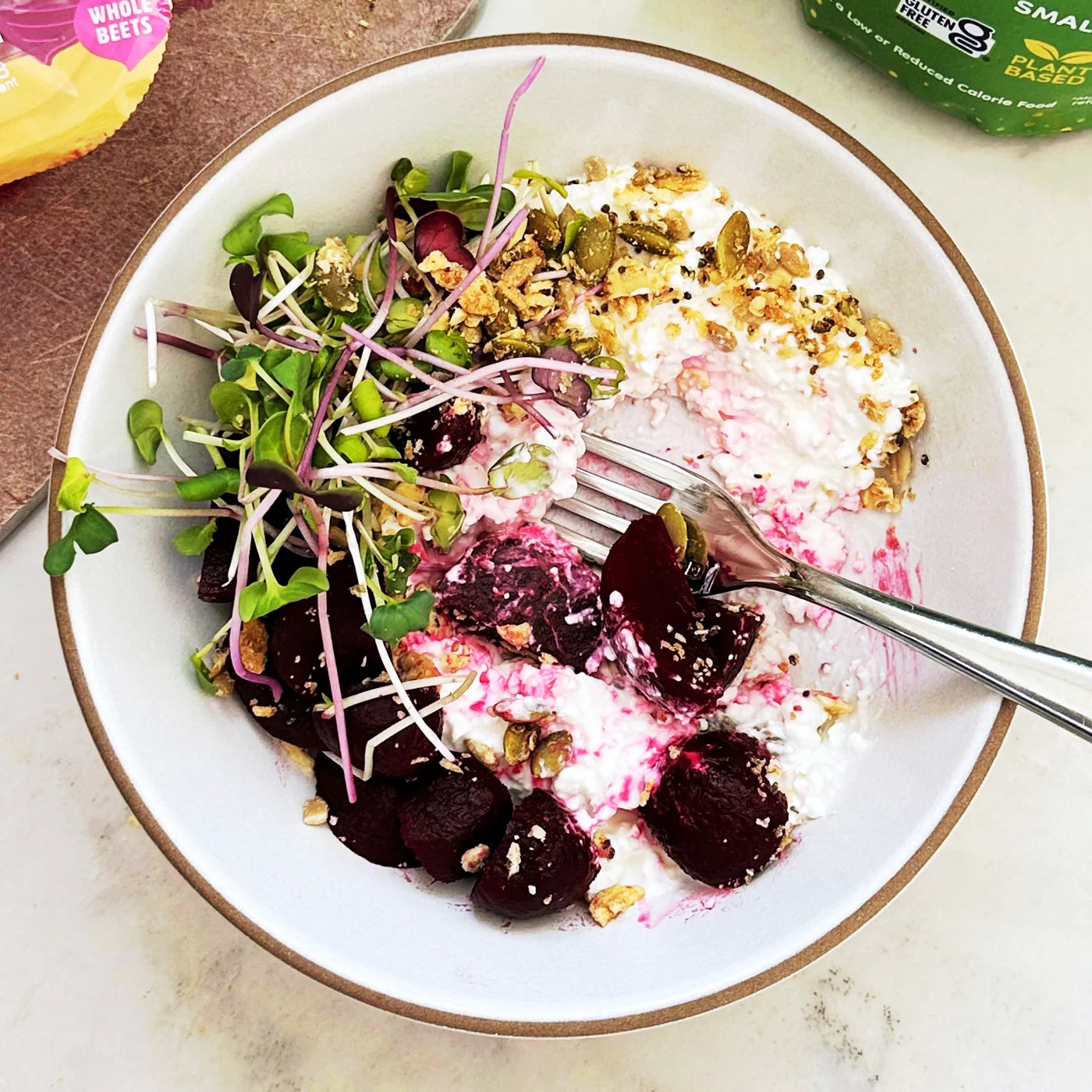 Pickled beets and cottage cheese in a bowl with microgreens and Struesli Savory + Seed