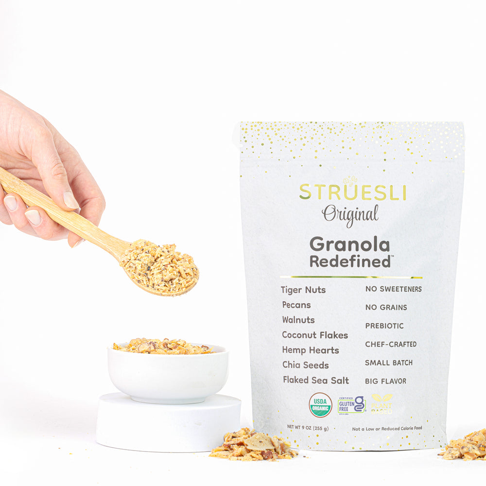 A package of Struesli Original granola next to a bowl and spoonful of granola