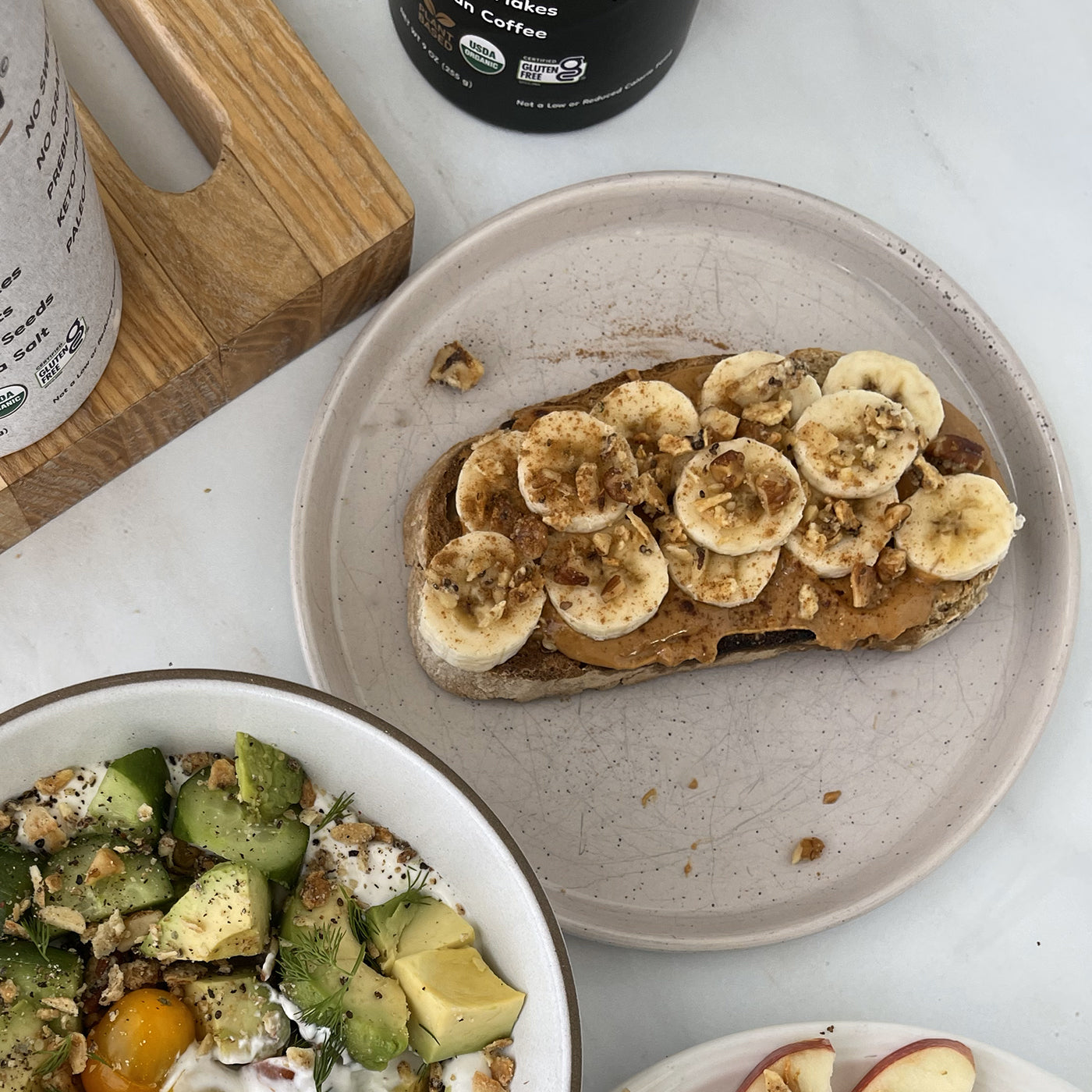 Peanut butter and banana toast topped with Struesli granola on a plate
